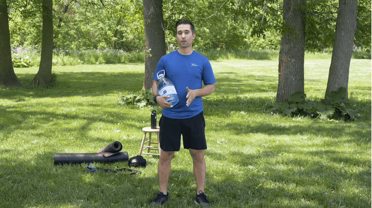 Man holding water bottle standing outside