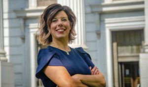 A woman standing with arms crossed