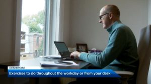 A person on their laptop behind a desk