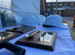 A table with blue hard (construction) hats and awards plaques