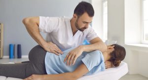 A chiropractor providing care to a patient