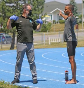 Canadian sprinter Andre De Grasse, right, visited the track at St. Mary’s Catholic Secondary School in Cobourg on June 28, where he received treatment from Dr. Alban Merepeza, his sports chiropractor.