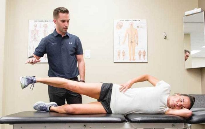 Dr. Welsh delivering chiropractic care to one of many office athletes