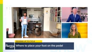 Dr. Gray joins The Morning Show via Skype standing with bike