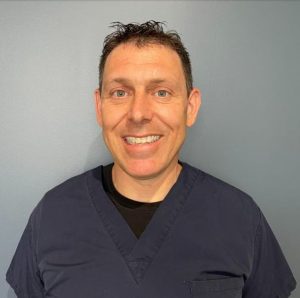 Portrait style image of chiropractor Dr. Lisser smiling