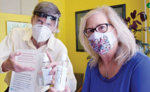 Dr. Matheson and wife in PPE at office