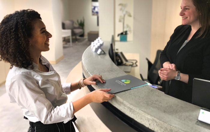 Nardine speaking to clinic receptionist