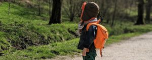 child practising backpack safety