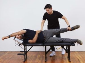 A chiropractor treating a patient