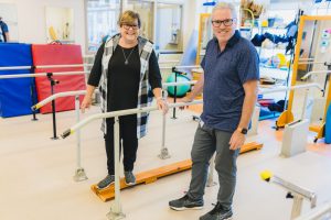 Angela Sage posing with physiotherapist Mike Finlay at HHS's Regional Rehabilitation Centre.