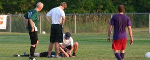 athletes on a field to show how to manage a concussion