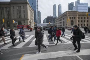 People crossing the street on a busy road