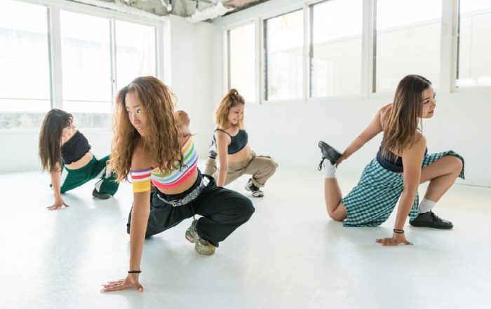 modern dancers practicing in white studio space