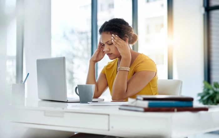 woman with headache at work
